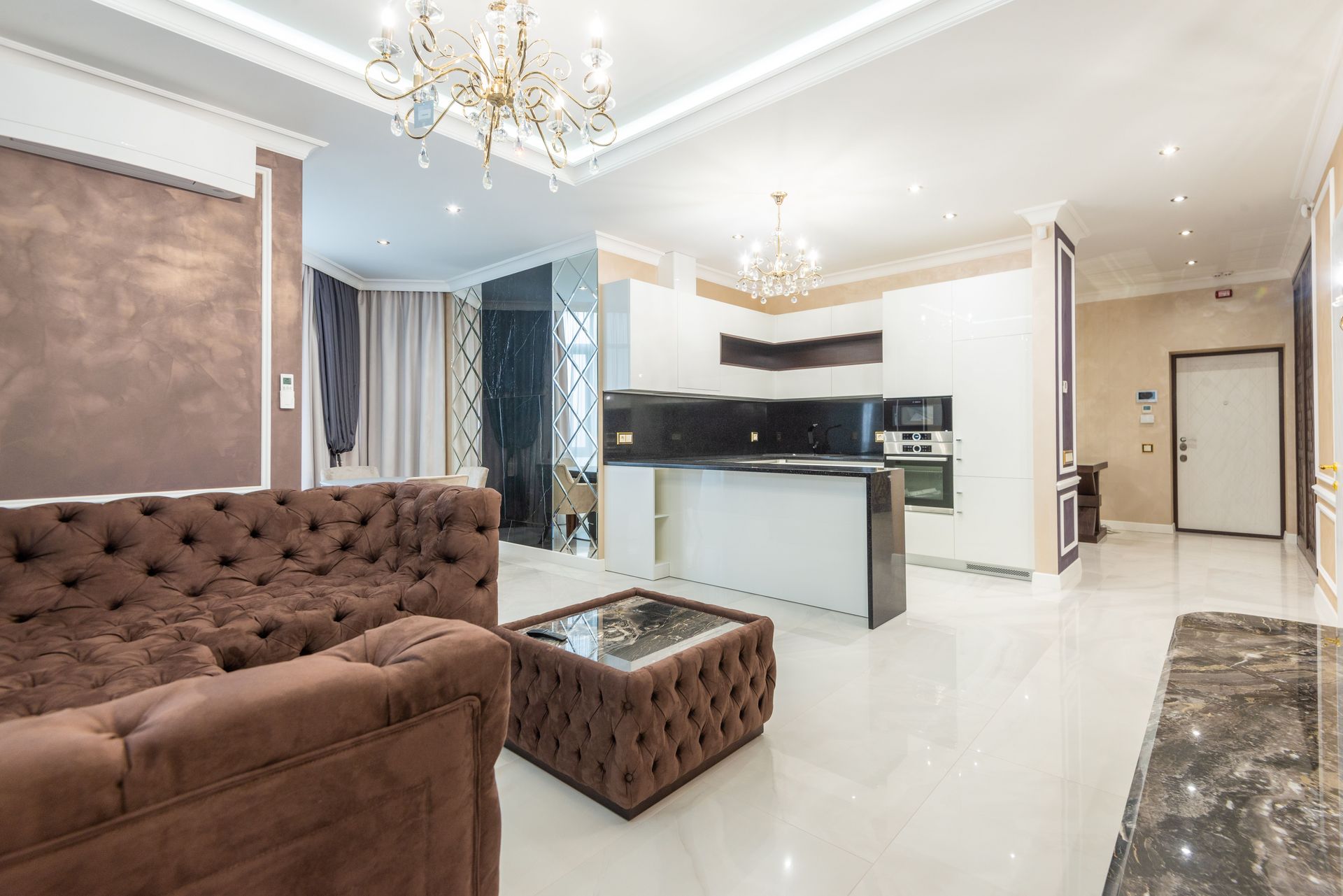Luxurious open-plan living room with modern interior design and stylish lighting features.